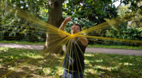 jesús rafael soto suspends 4,000 yellow strands in kensington gardens for serpentine
